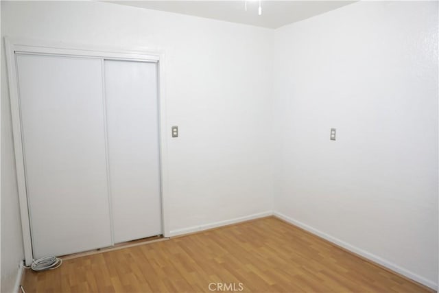 15154 Oliva Ave, Paramount, CA 90723 - unfurnished bedroom with light wood finished floors and a closet