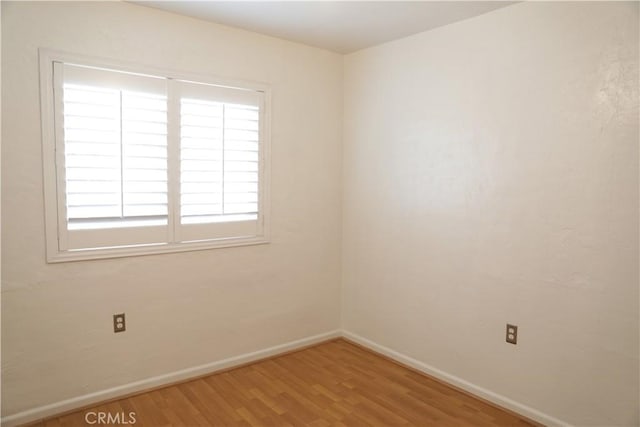 15154 Oliva Ave, Paramount, CA 90723 - empty room with wood finished floors and baseboards