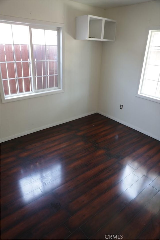 15154 Oliva Ave, Paramount, CA 90723 - unfurnished room with dark wood finished floors and plenty of natural light