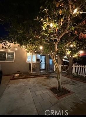 15154 Oliva Ave, Paramount, CA 90723 - view of property hidden behind natural elements featuring stucco siding and a patio area