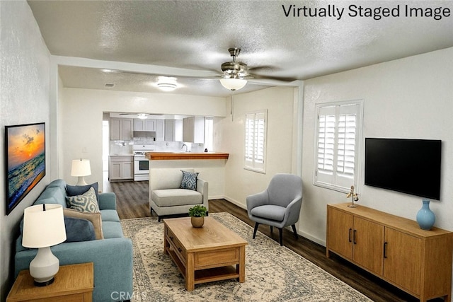 15154 Oliva Ave, Paramount, CA 90723 - living area with ceiling fan, dark wood finished floors, and a textured ceiling