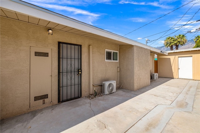 509561 S Highland Dr, Palm Springs, CA 92264 - view of exterior entry with stucco siding and a patio
