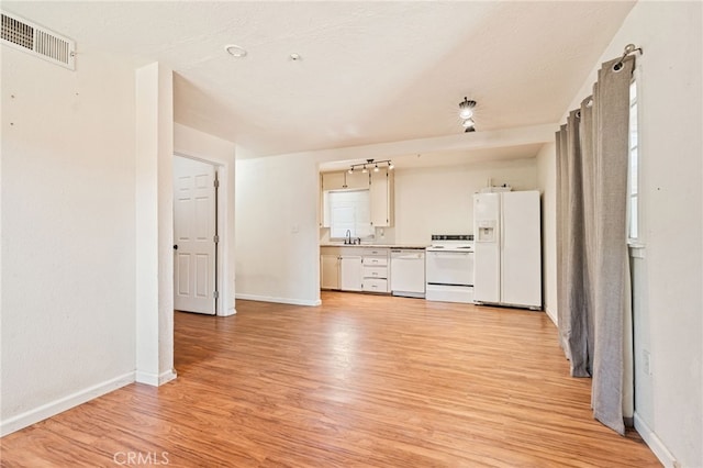 4491 N Dewitt Ave, Fresno, CA 93727 - kitchen with white appliances, light wood-type flooring, light countertops, and white cabinets
