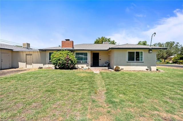 4491 N Dewitt Ave, Fresno, CA 93727 - rear view of property featuring a chimney, a lawn, and stucco siding
