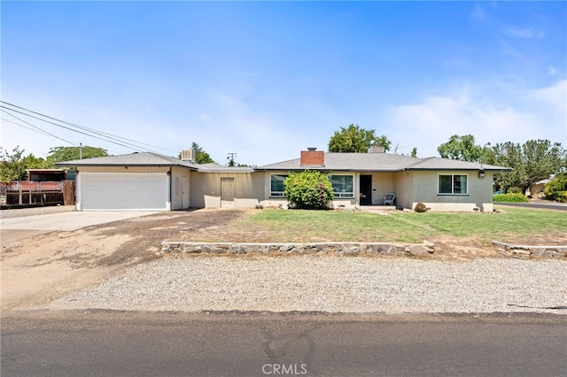 4491 N Dewitt Ave, Fresno, CA 93727 - single story home with driveway, a garage, a front yard, and a chimney