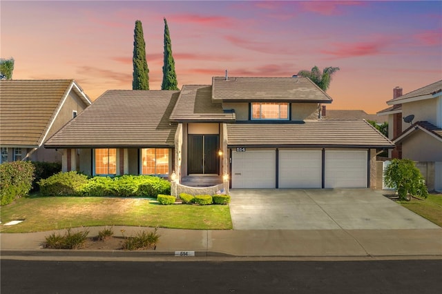 514 Mohawk Dr, Placentia, CA 92870 - view of front of home with a tile roof, driveway, a front yard, a garage, and stucco siding