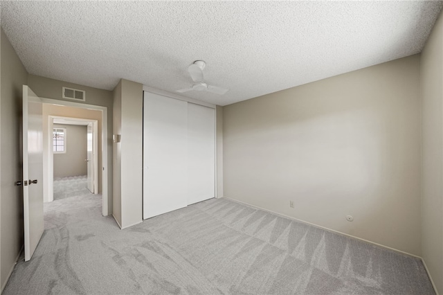 514 Mohawk Dr, Placentia, CA 92870 - unfurnished bedroom featuring light carpet, a closet, a ceiling fan, and a textured ceiling