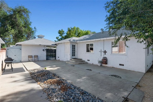 1414 W Jackman St, Lancaster, CA 93534 - back of house featuring a gate, crawl space, a patio area, and stucco siding