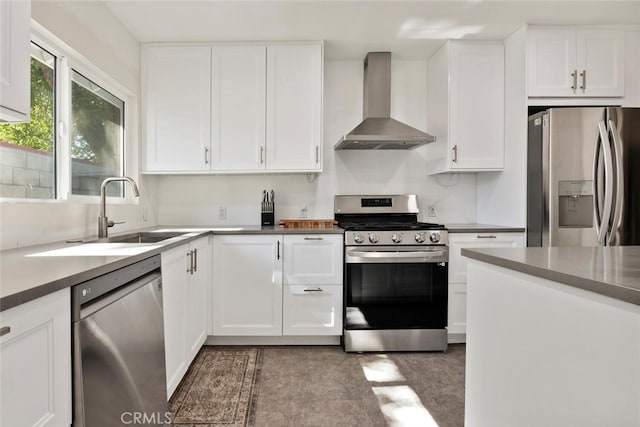 1414 W Jackman St, Lancaster, CA 93534 - kitchen featuring wall chimney range hood, appliances with stainless steel finishes, and white cabinetry