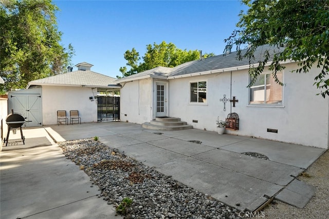 1414 W Jackman St, Lancaster, CA 93534 - rear view of house with a gate, stucco siding, and a patio