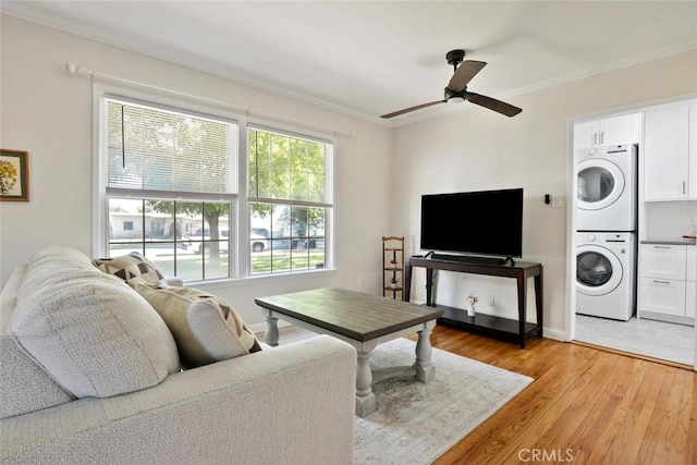 1414 W Jackman St, Lancaster, CA 93534 - living area featuring stacked washer and clothes dryer, crown molding, a ceiling fan, and light wood-type flooring