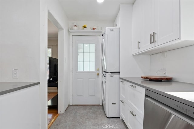 1414 W Jackman St, Lancaster, CA 93534 - kitchen featuring stainless steel dishwasher, stacked washer and clothes dryer, and white cabinets