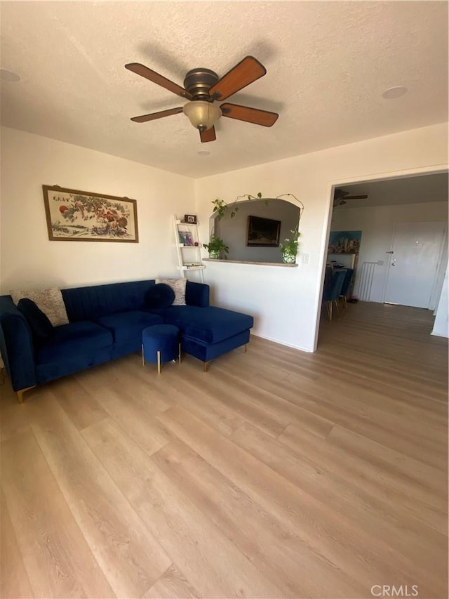 1640 Neil Armstrong St Unit 306, Montebello, CA 90640 - living area featuring light wood-style flooring, a ceiling fan, and a textured ceiling
