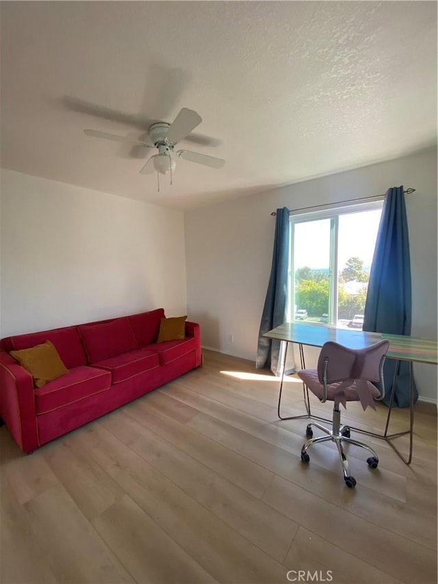 1640 Neil Armstrong St Unit 306, Montebello, CA 90640 - living area featuring wood finished floors, a desk, a ceiling fan, and a textured ceiling