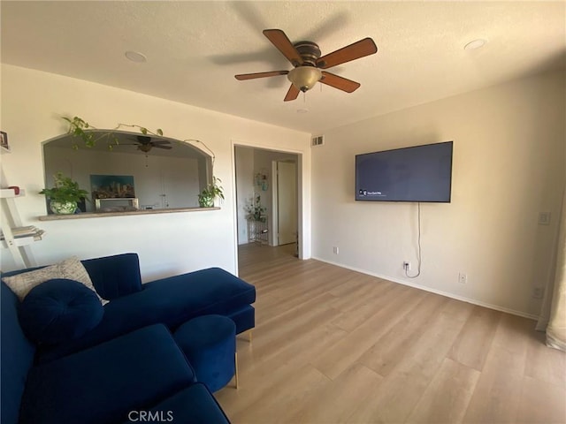 1640 Neil Armstrong St Unit 306, Montebello, CA 90640 - living area featuring ceiling fan, light wood finished floors, and a textured ceiling