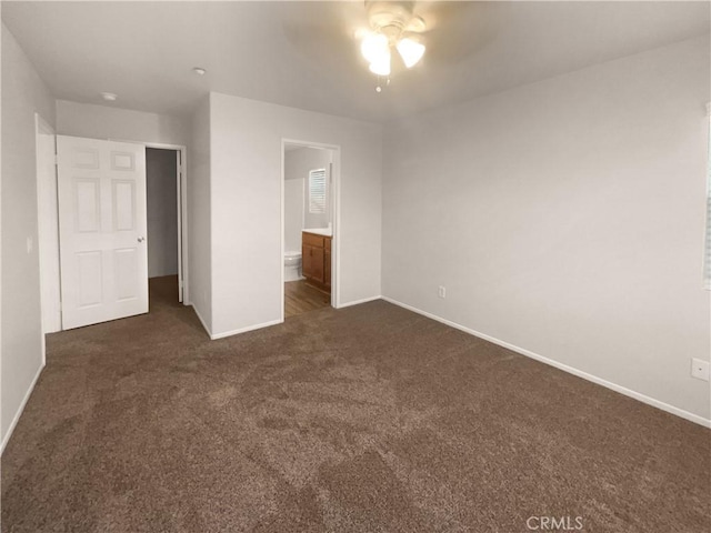 15617 Lasselle St Unit 31, Moreno Valley, CA 92551 - unfurnished bedroom with dark colored carpet, ensuite bathroom, and a ceiling fan