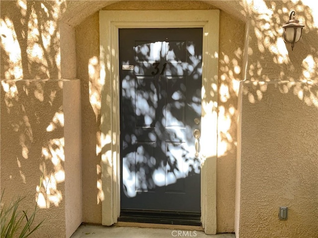 15617 Lasselle St Unit 31, Moreno Valley, CA 92551 - doorway to property featuring stucco siding