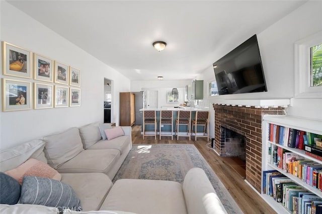 2082 Harris St, San Luis Obispo, CA 93401 - living room featuring wood finished floors and a brick fireplace