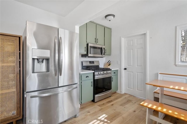 2082 Harris St, San Luis Obispo, CA 93401 - kitchen featuring stainless steel appliances, green cabinets, light wood-style floors, and light countertops
