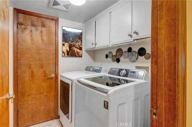 6272 Riviera Cir, Long Beach, CA 90815 - laundry room with cabinet space, washer and clothes dryer, and a textured ceiling
