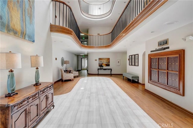 6272 Riviera Cir, Long Beach, CA 90815 - entrance foyer featuring a high ceiling and light wood-style floors