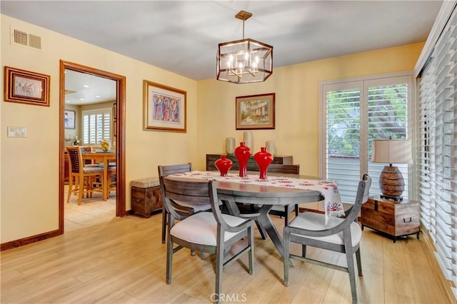 6272 Riviera Cir, Long Beach, CA 90815 - dining room featuring light wood-type flooring, a chandelier, and healthy amount of natural light