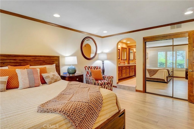 6272 Riviera Cir, Long Beach, CA 90815 - bedroom featuring arched walkways, ornamental molding, recessed lighting, light wood-type flooring, and connected bathroom