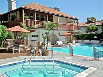 6272 Riviera Cir, Long Beach, CA 90815 - rear view of property featuring a balcony, a hot tub, and a tiled roof