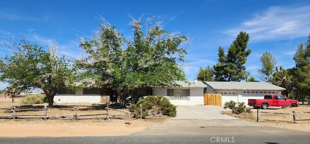 14450 Jicarilla Rd, Apple Valley, CA 92307 - view of front of property with concrete driveway, an attached garage, and stucco siding