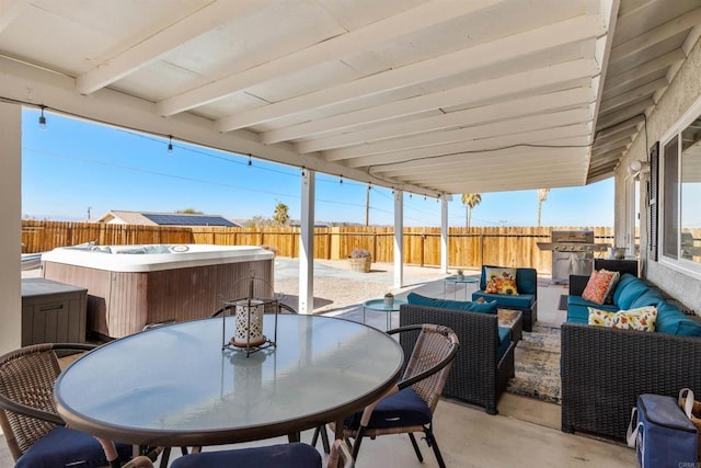6636 Indian Cove Rd Unit 29, Palms, CA 92277 - fenced backyard with a hot tub, a patio area, an outdoor living space, outdoor dining area, and area for grilling