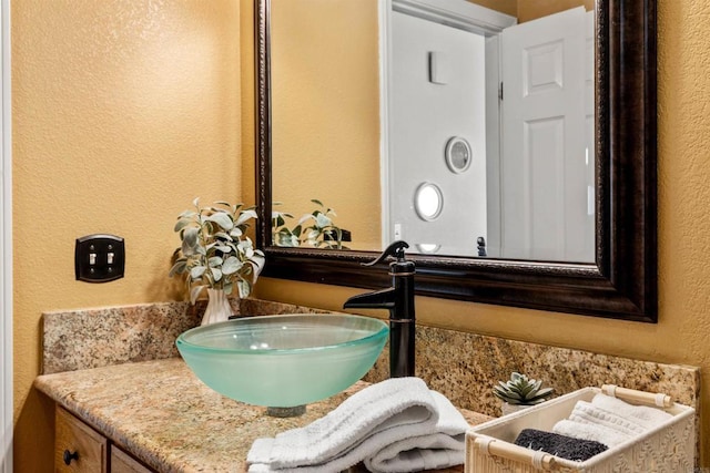 6636 Indian Cove Rd Unit 29, Palms, CA 92277 - bathroom featuring a textured wall and vanity