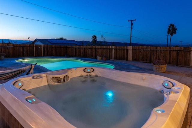 6636 Indian Cove Rd Unit 29, Palms, CA 92277 - view of pool with a hot tub and a fenced backyard