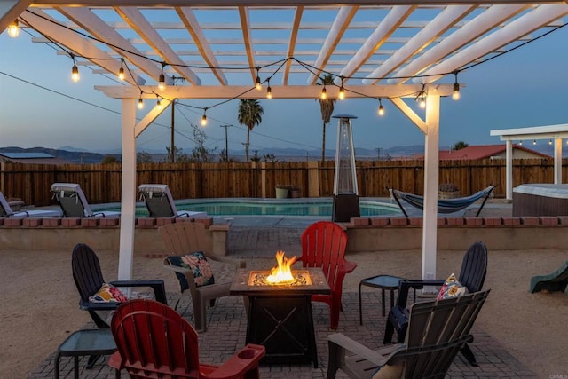 6636 Indian Cove Rd Unit 29, Palms, CA 92277 - fenced backyard with an outdoor fire pit, a pergola, a jacuzzi, and a patio