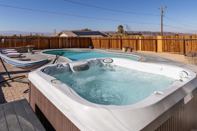 6636 Indian Cove Rd Unit 29, Palms, CA 92277 - view of pool featuring a hot tub and a fenced backyard
