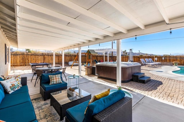 6636 Indian Cove Rd Unit 29, Palms, CA 92277 - fenced backyard featuring a hot tub, outdoor lounge area, a patio, and outdoor dining space