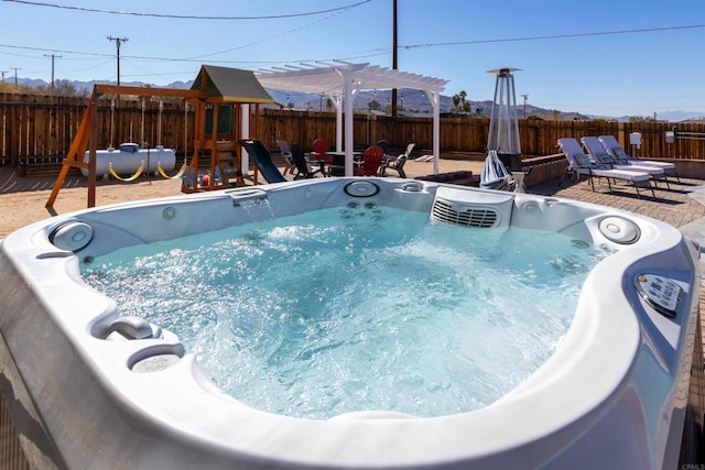 6636 Indian Cove Rd Unit 29, Palms, CA 92277 - view of swimming pool with a playground, a hot tub, and a fenced backyard