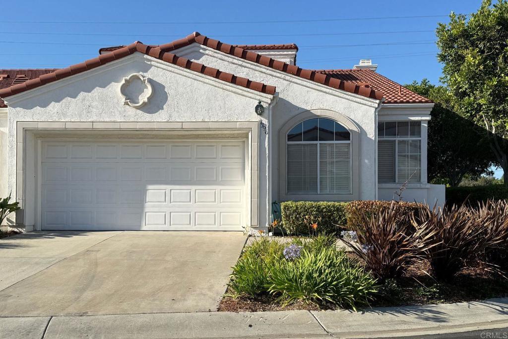 3396 Corsica Way, Oceanside, CA 92056 - mediterranean / spanish-style house with an attached garage, driveway, a tile roof, stucco siding, and a chimney