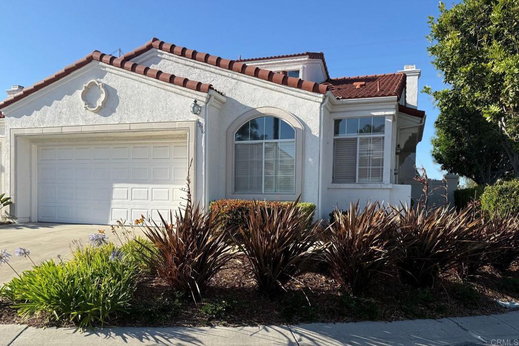 3396 Corsica Way, Oceanside, CA 92056 - mediterranean / spanish home featuring an attached garage, stucco siding, concrete driveway, and a tiled roof