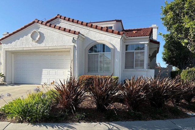 3396 Corsica Way, Oceanside, CA 92056 - mediterranean / spanish home featuring an attached garage, stucco siding, concrete driveway, and a tiled roof