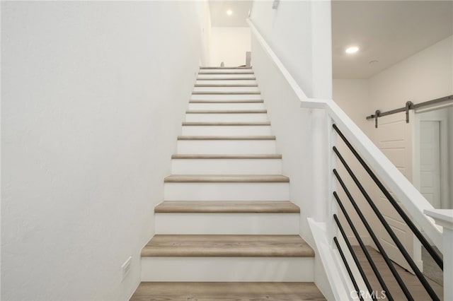 480 W Balsam Ln, Clovis, CA 93611 - stairway featuring a barn door, wood finished floors, and recessed lighting