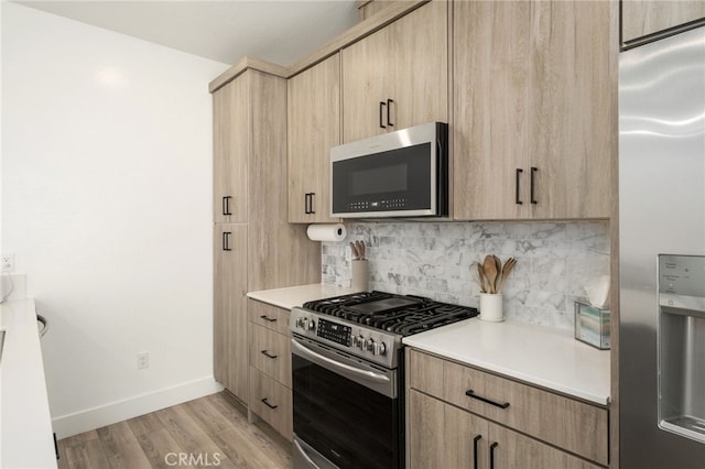 480 W Balsam Ln, Clovis, CA 93611 - kitchen with appliances with stainless steel finishes, light brown cabinetry, tasteful backsplash, and light countertops