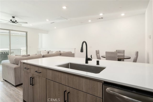 480 W Balsam Ln, Clovis, CA 93611 - kitchen with stainless steel dishwasher, light wood-style floors, a ceiling fan, light countertops, and recessed lighting