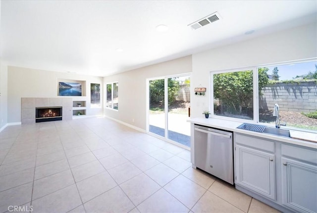 26932 St Julian Cir, Murrieta, CA 92563 - kitchen featuring dishwasher, light tile patterned flooring, light countertops, and a fireplace