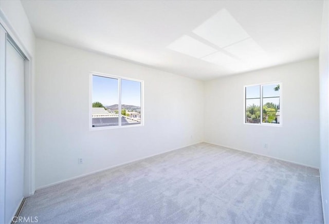 26932 St Julian Cir, Murrieta, CA 92563 - empty room featuring plenty of natural light, light carpet, and a skylight