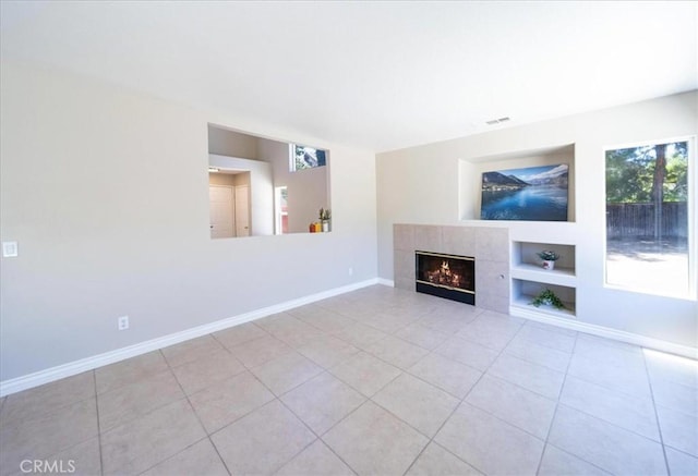 26932 St Julian Cir, Murrieta, CA 92563 - unfurnished living room featuring built in features, tile patterned floors, and a fireplace