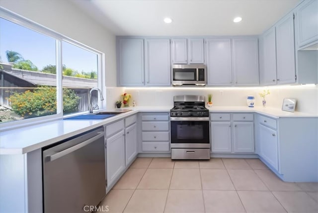 26932 St Julian Cir, Murrieta, CA 92563 - kitchen featuring appliances with stainless steel finishes, light countertops, backsplash, light tile patterned floors, and recessed lighting