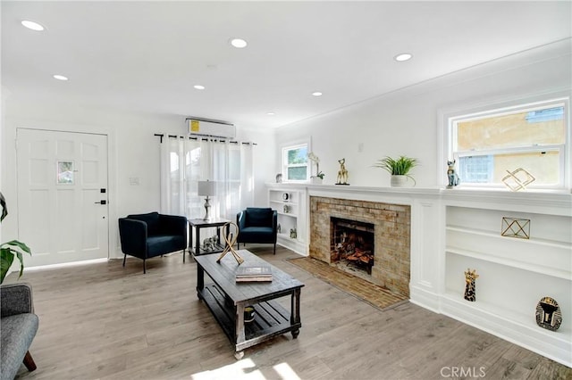 5737 5th, Los Angeles, CA 90043 - living area featuring light wood-style floors, a fireplace with flush hearth, recessed lighting, and built in shelves