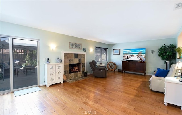 25355 Auld Ave, Hemet, CA 92544 - living area featuring light wood-type flooring, healthy amount of natural light, and a tiled fireplace