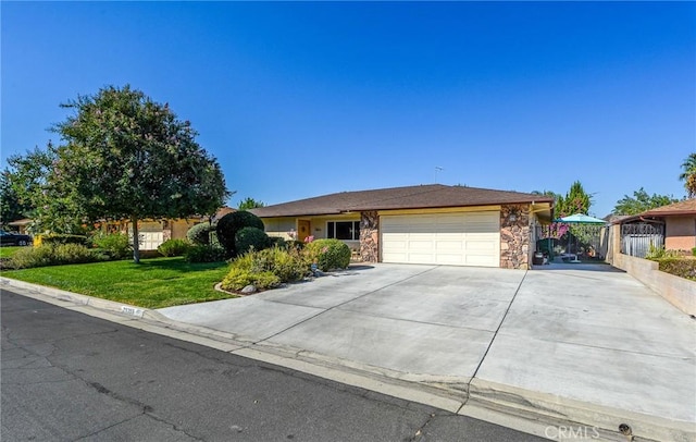 25355 Auld Ave, Hemet, CA 92544 - ranch-style house with concrete driveway, a garage, and stone siding