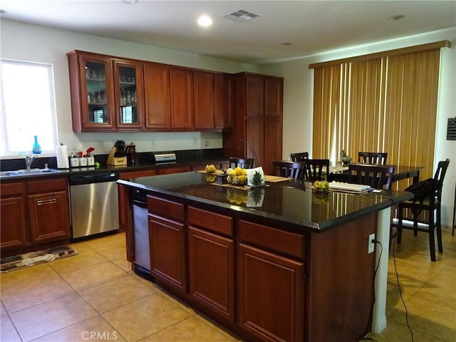 43890 Moccasin Pl, Lancaster, CA 93536 - kitchen featuring dishwasher, light tile patterned floors, a kitchen island, glass insert cabinets, and recessed lighting